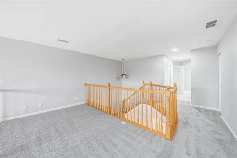 a view of a hallway with staircase