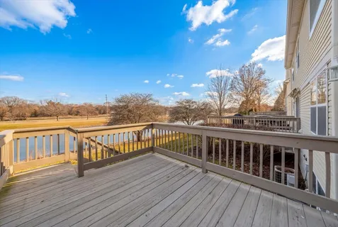 a view of roof deck with two chairs and wooden floor
