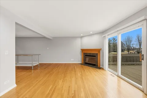 a view of empty room with a fireplace and wooden floor
