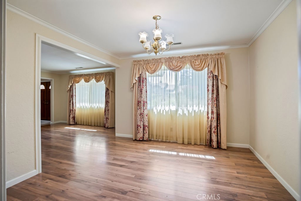 2960 Whitegate Drive Merced, CA 95340 - Photo 20 of 48 a view of an empty room with wooden floor and a window