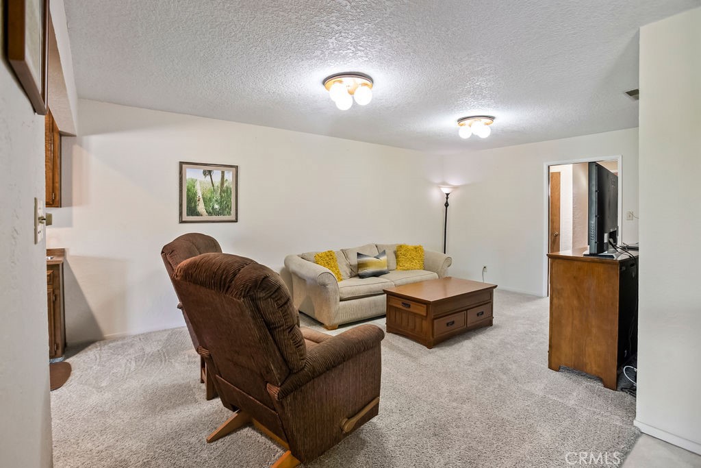 2960 Whitegate Drive Merced, CA 95340 - Photo 24 of 48 a living room with furniture and a flat screen tv