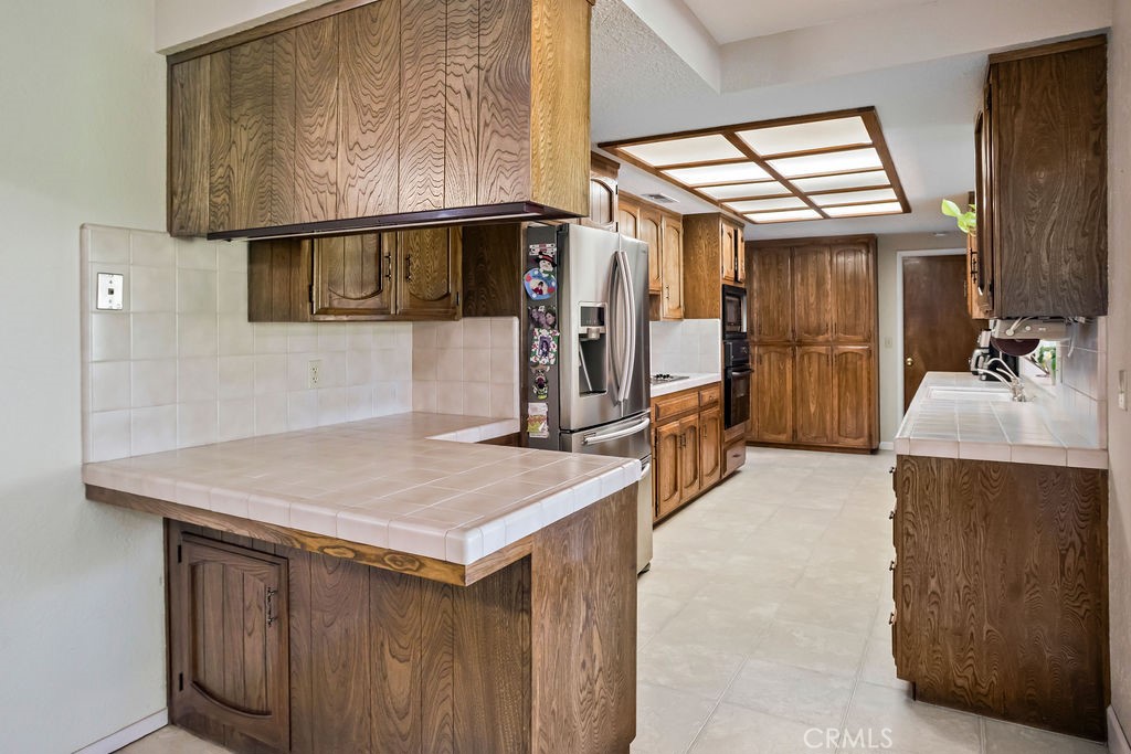 2960 Whitegate Drive Merced, CA 95340 - Photo 25 of 48 a kitchen that has a sink and a wooden floor