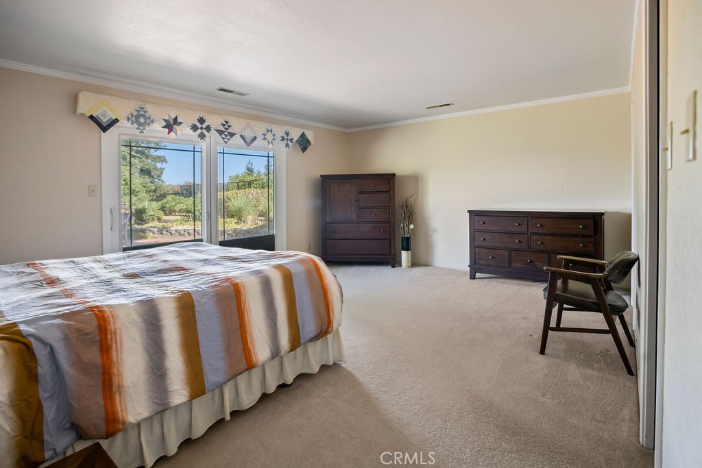 2960 Whitegate Drive Merced, CA 95340 - Photo 36 of 48 a bedroom with a bed and a chandelier