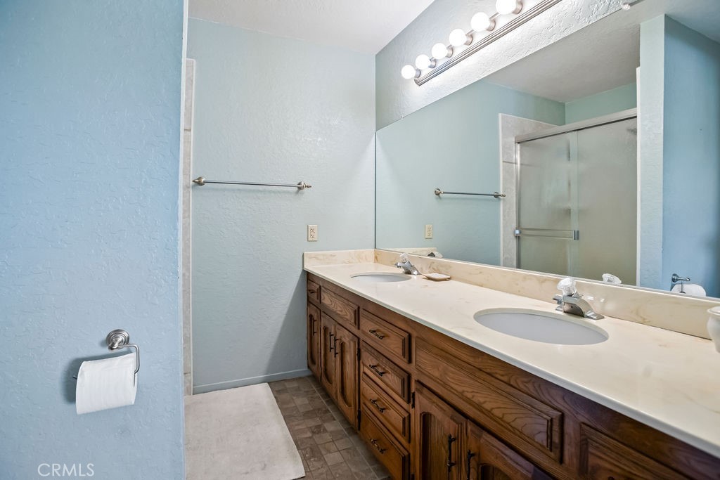 2960 Whitegate Drive Merced, CA 95340 - Photo 38 of 48 a bathroom with a double vanity sink a and mirror