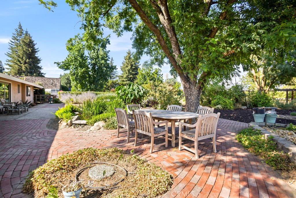 2960 Whitegate Drive Merced, CA 95340 - Photo 45 of 48 a view of a backyard with table and chairs potted plants and large tree