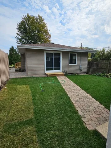 a front view of a house with a garden and yard