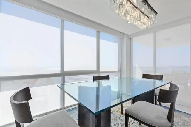 a bedroom with a bed and a floor to ceiling window