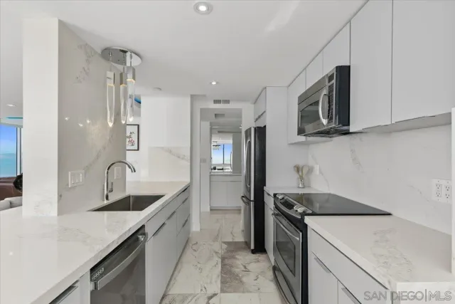 a bedroom with a bed mirror and on the dresser