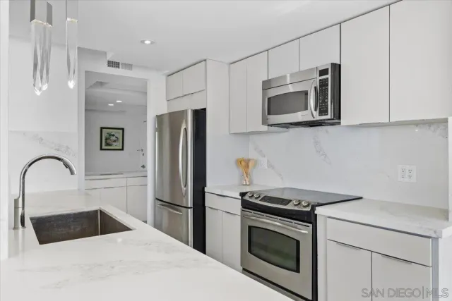 a bed sitting in a kitchen next to a window