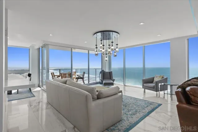 a living room with furniture or chandelier and a glass door