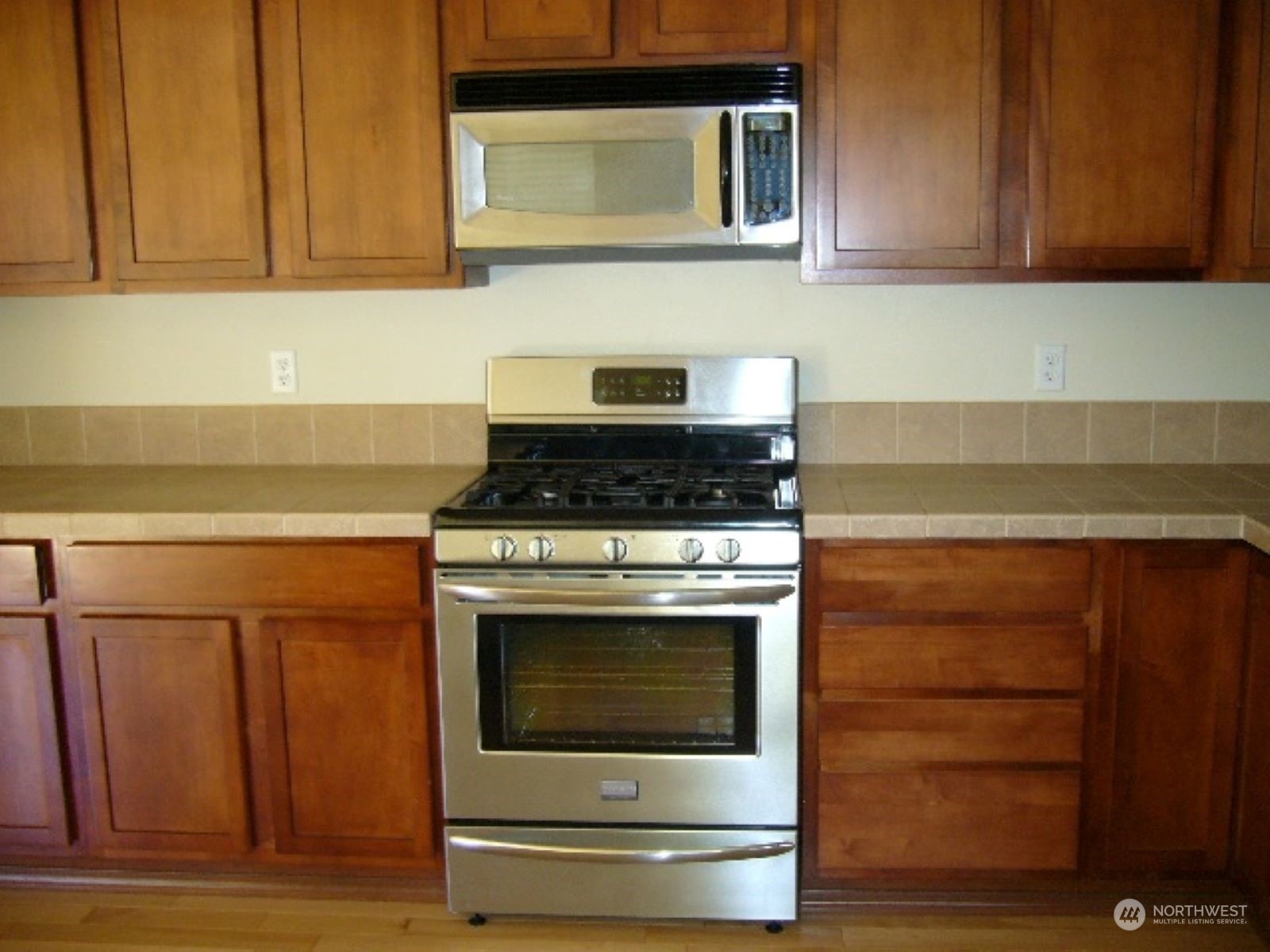3602 154th Place Southeast Bothell, WA 98012 - Photo 7 of 22 a stove top oven sitting inside of a kitchen