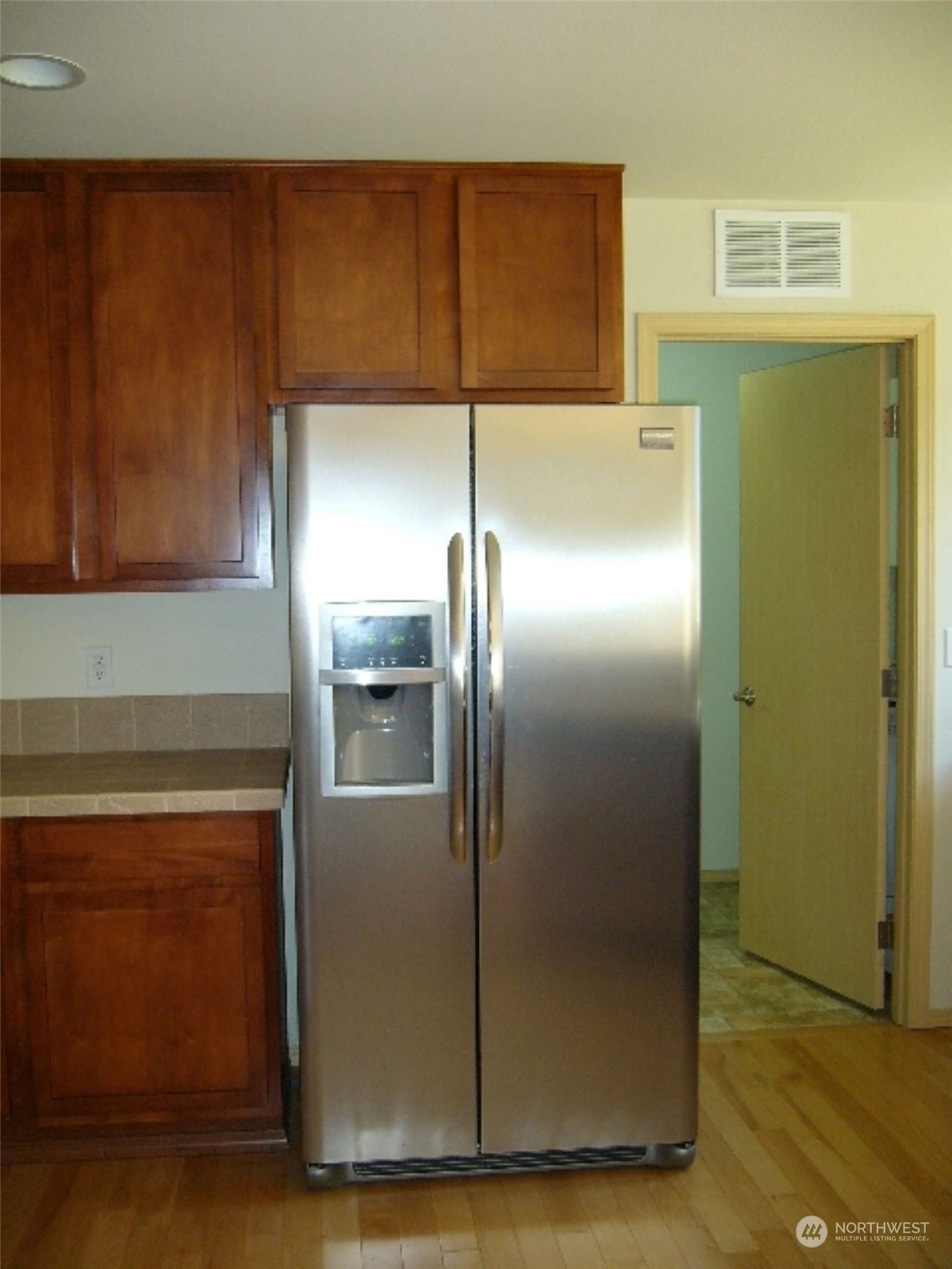 3602 154th Place Southeast Bothell, WA 98012 - Photo 8 of 22 a kitchen with a refrigerator and cabinets