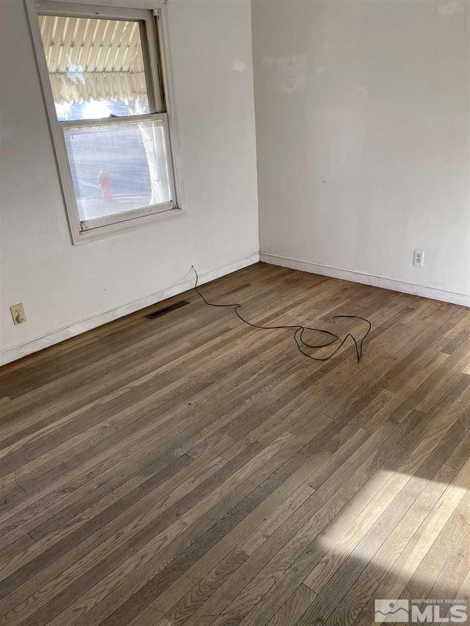 190 Bartlett Street Reno, NV 89512 - Photo 1 of 1 an empty room with wooden floor and windows