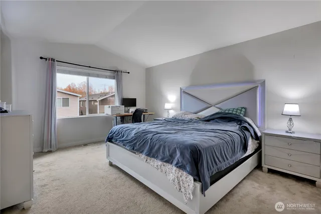 a spacious bedroom with a bed and window