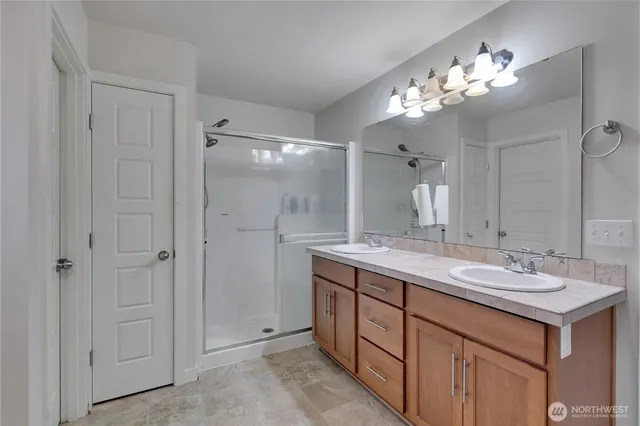 a bathroom with a double vanity sink and a mirror