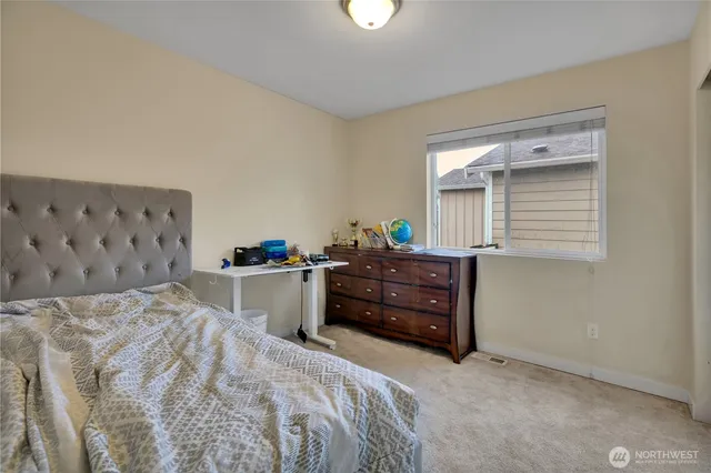 a bedroom with a bed and a dresser