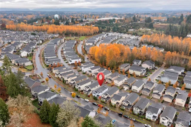 an aerial view of a house with a yard