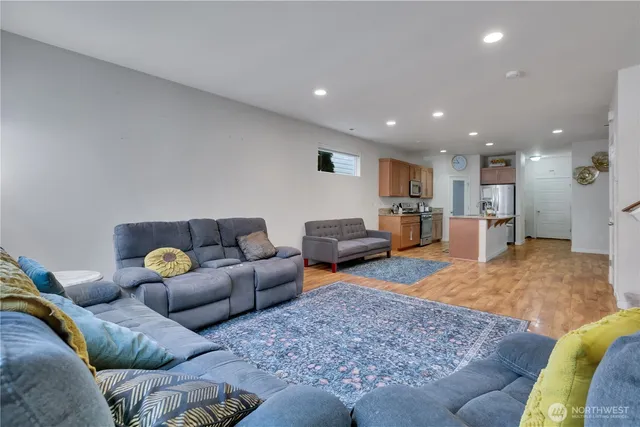 a living room with furniture and kitchen view