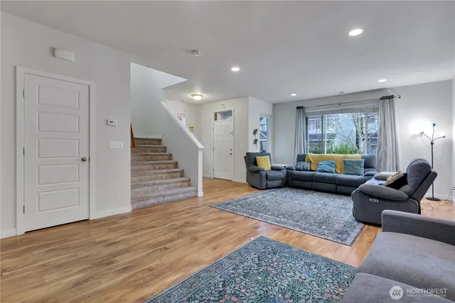 a living room with furniture and wooden floor