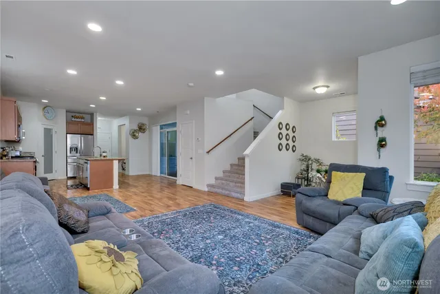 a living room with furniture and wooden floor