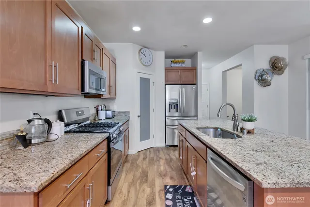 a kitchen with granite countertop a sink and cabinets