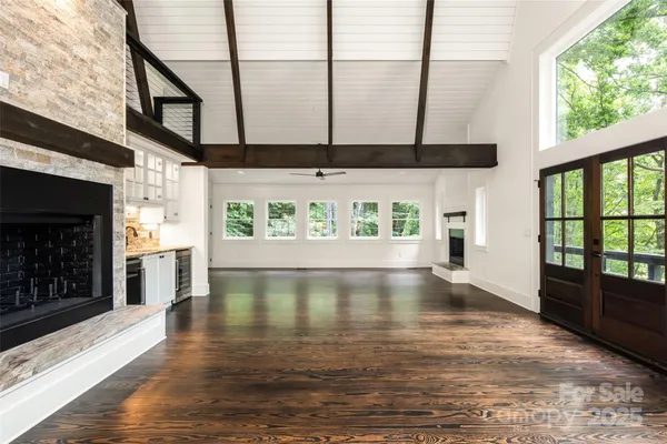 a living room with a fireplace a sink and a window