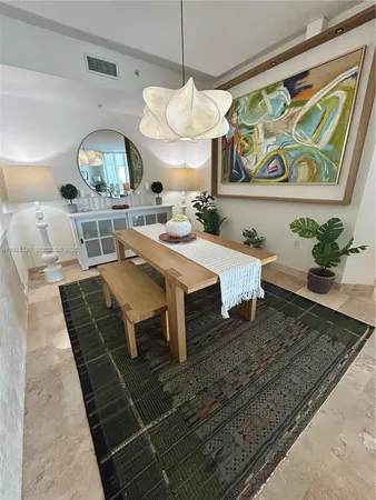a living room with table and chairs