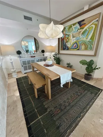 a living room with table and chairs