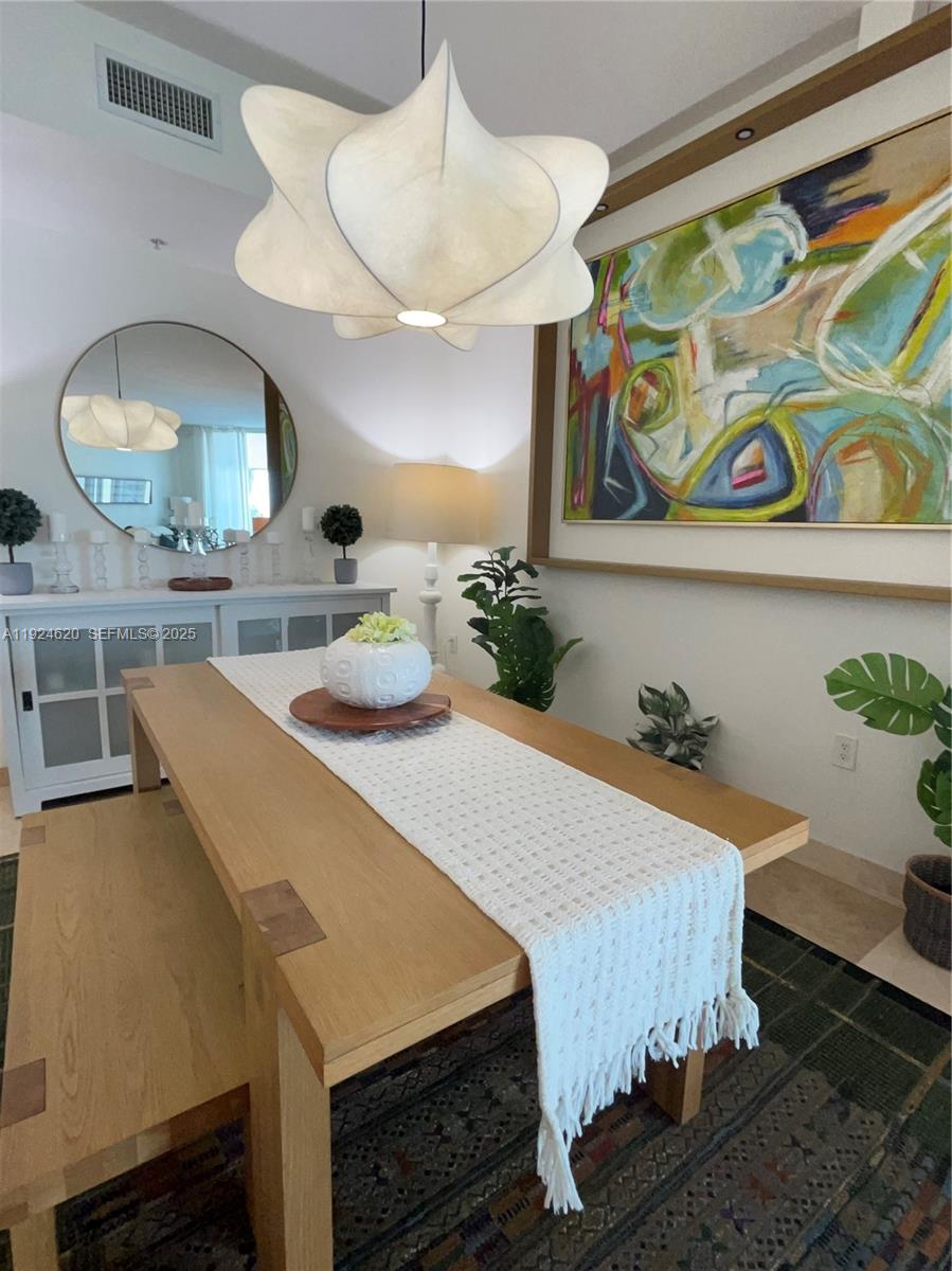 9055 Southwest 73rd Court, Unit 809 Miami, FL 33156 - Photo 12 of 47 a bed room with a bed mirror and a table