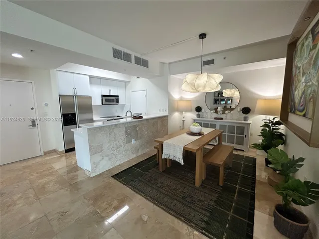 a large kitchen with a table and chairs