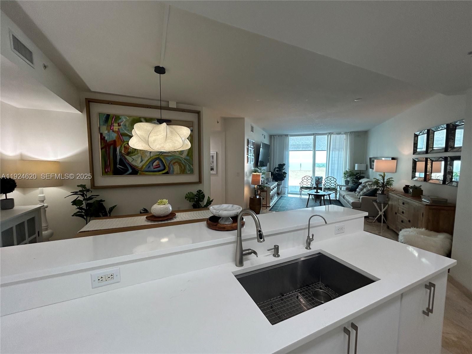 9055 Southwest 73rd Court, Unit 809 Miami, FL 33156 - Photo 17 of 47 a living room with furniture and a flat screen tv