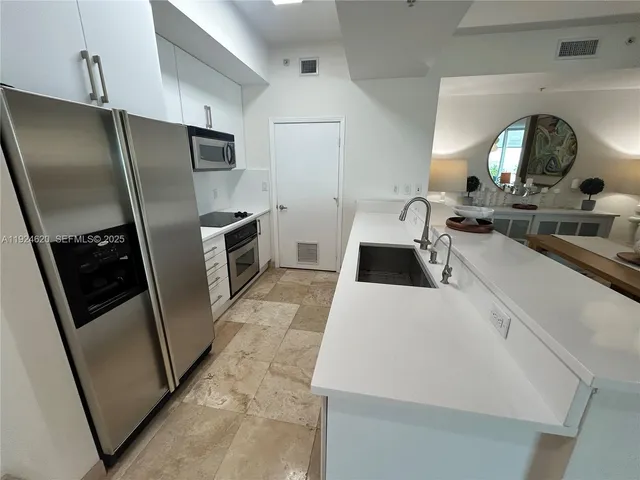 a kitchen with a refrigerator sink and stove
