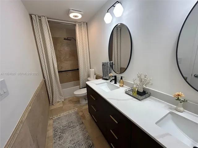 a bathroom with a double vanity sink and a mirror