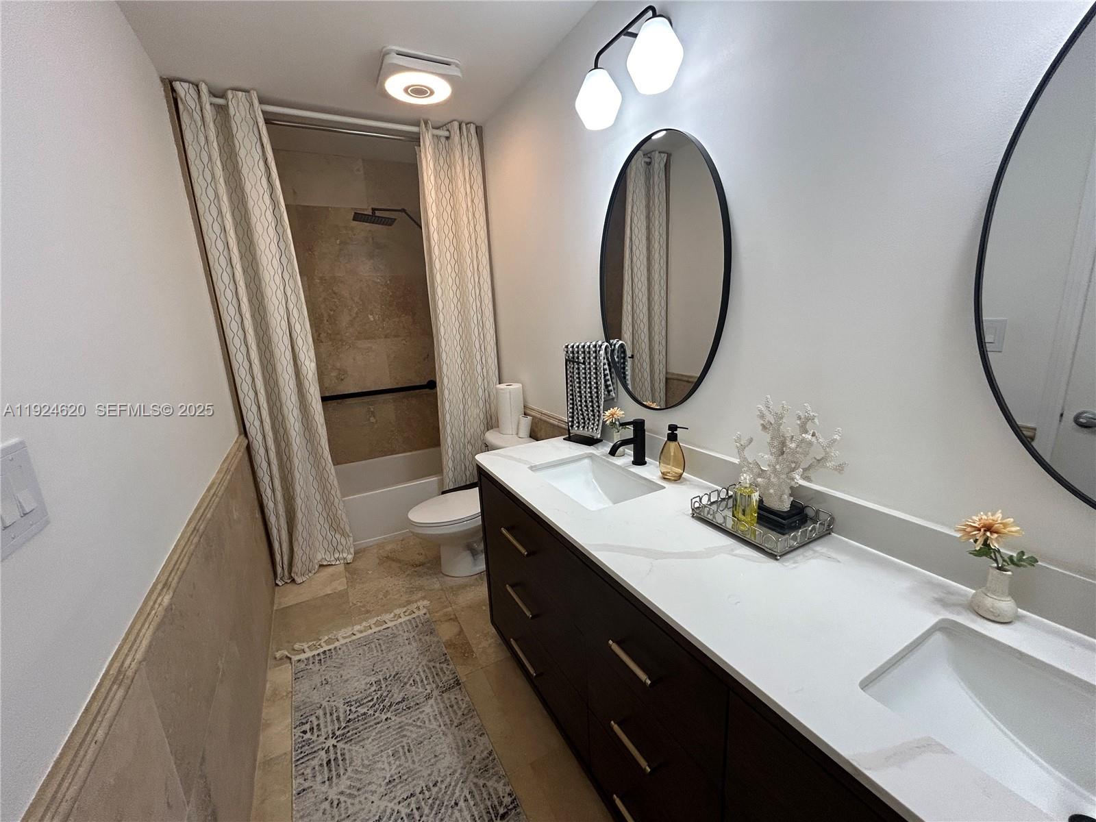 9055 Southwest 73rd Court, Unit 809 Miami, FL 33156 - Photo 20 of 47 a bathroom with a double vanity sink and a mirror