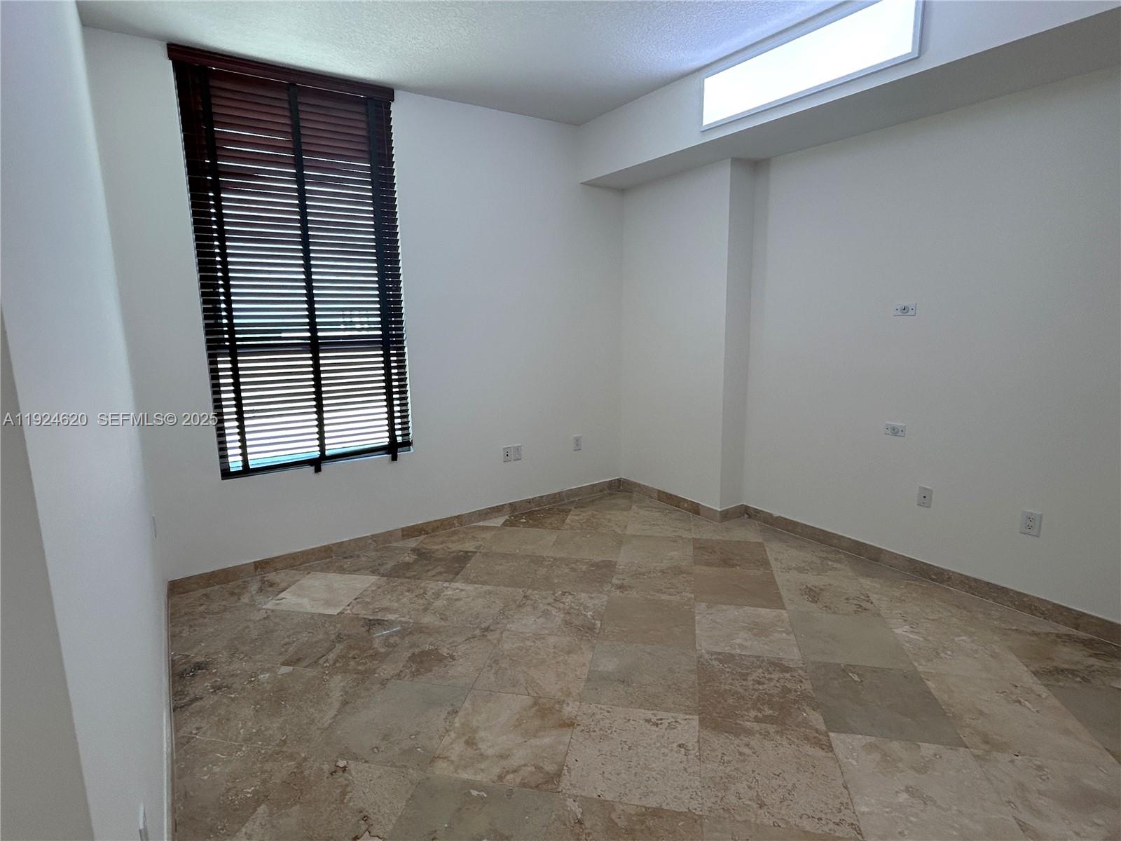 9055 Southwest 73rd Court, Unit 809 Miami, FL 33156 - Photo 23 of 47 an empty room with windows