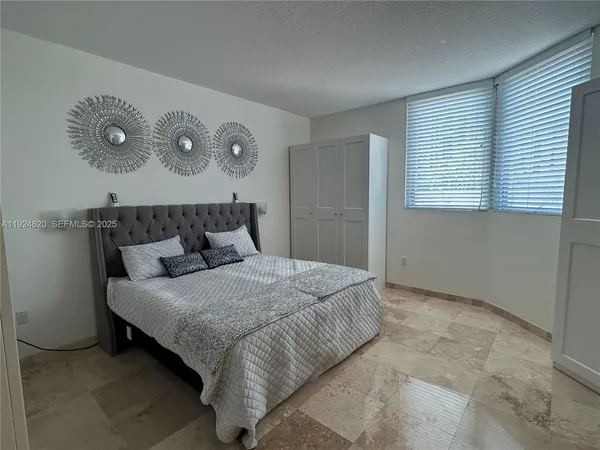 a bedroom with a bed and cabinets