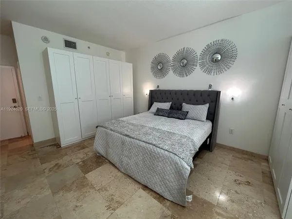 a bedroom with a bed and cabinets