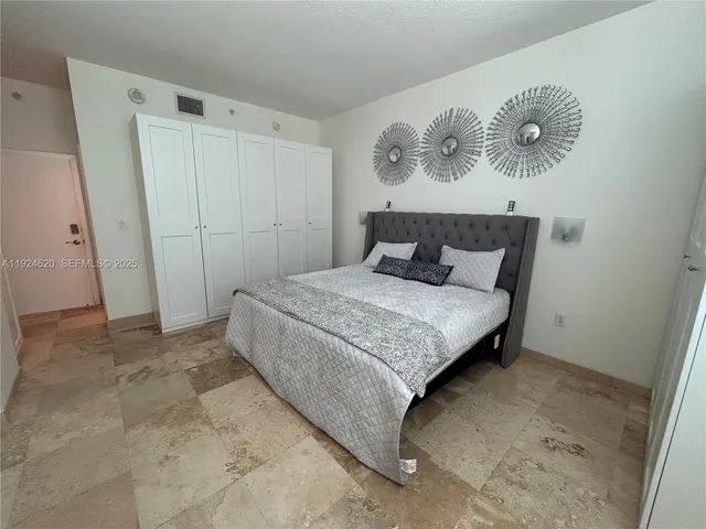 a bedroom with a bed and a closet