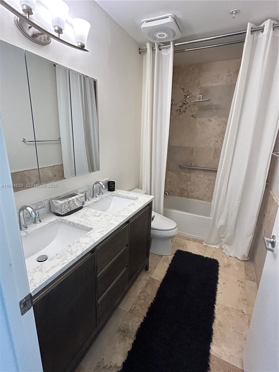 9055 Southwest 73rd Court, Unit 809 Miami, FL 33156 - Photo 31 of 47 a bathroom with a double vanity sink and a mirror