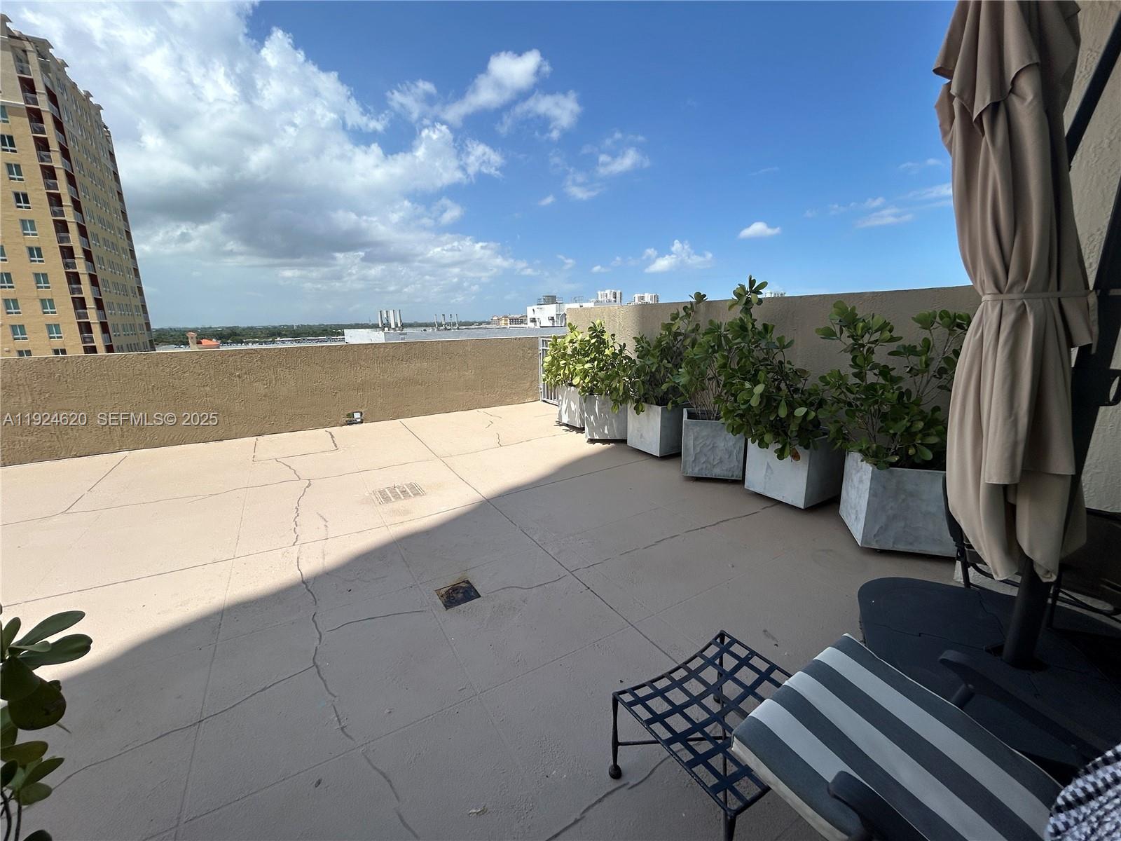 9055 Southwest 73rd Court, Unit 809 Miami, FL 33156 - Photo 37 of 47 a view of a terrace with sky view