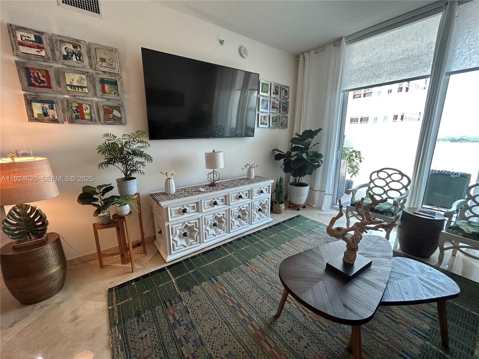 9055 Southwest 73rd Court, Unit 809 Miami, FL 33156 - Photo 6 of 47 a living room with furniture and a flat screen tv