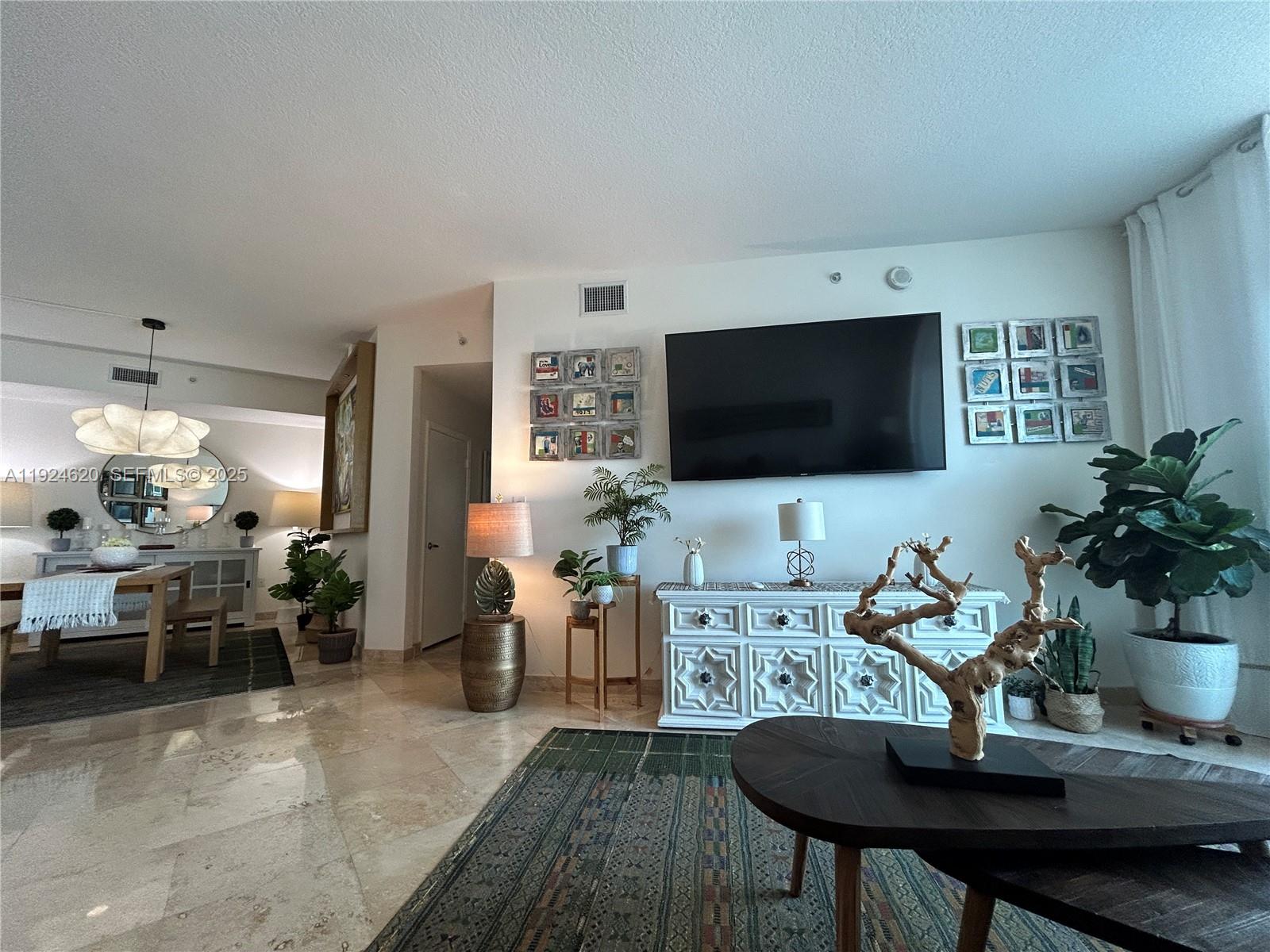 9055 Southwest 73rd Court, Unit 809 Miami, FL 33156 - Photo 9 of 47 a living room with furniture and a flat screen tv