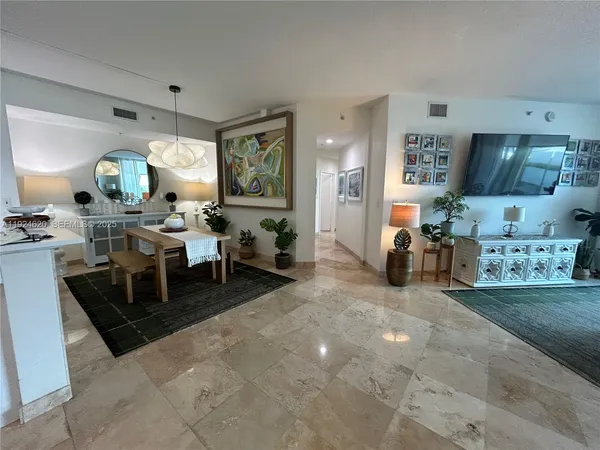 a living room with furniture and a mirror