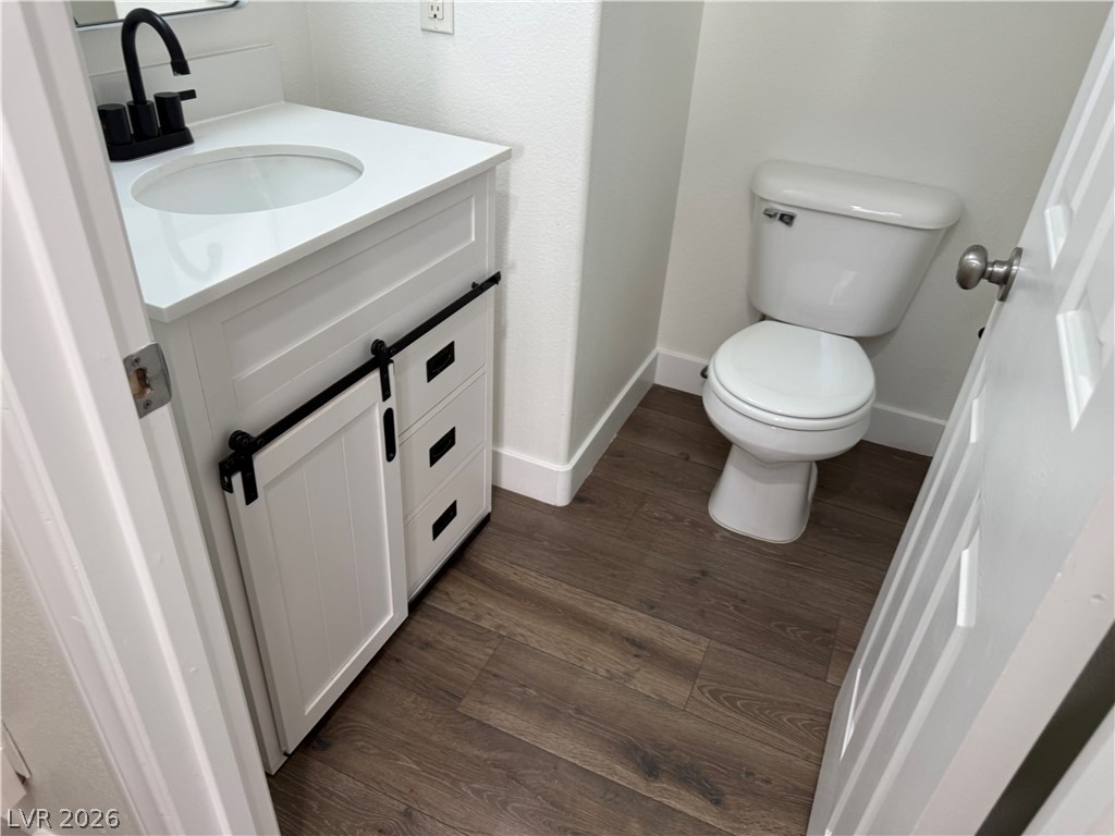 1141 Cathedral Ridge Street Henderson, NV 89052 - Photo 65 of 77 This bathroom features a contemporary vanity with a sliding barn door and durable flooring.