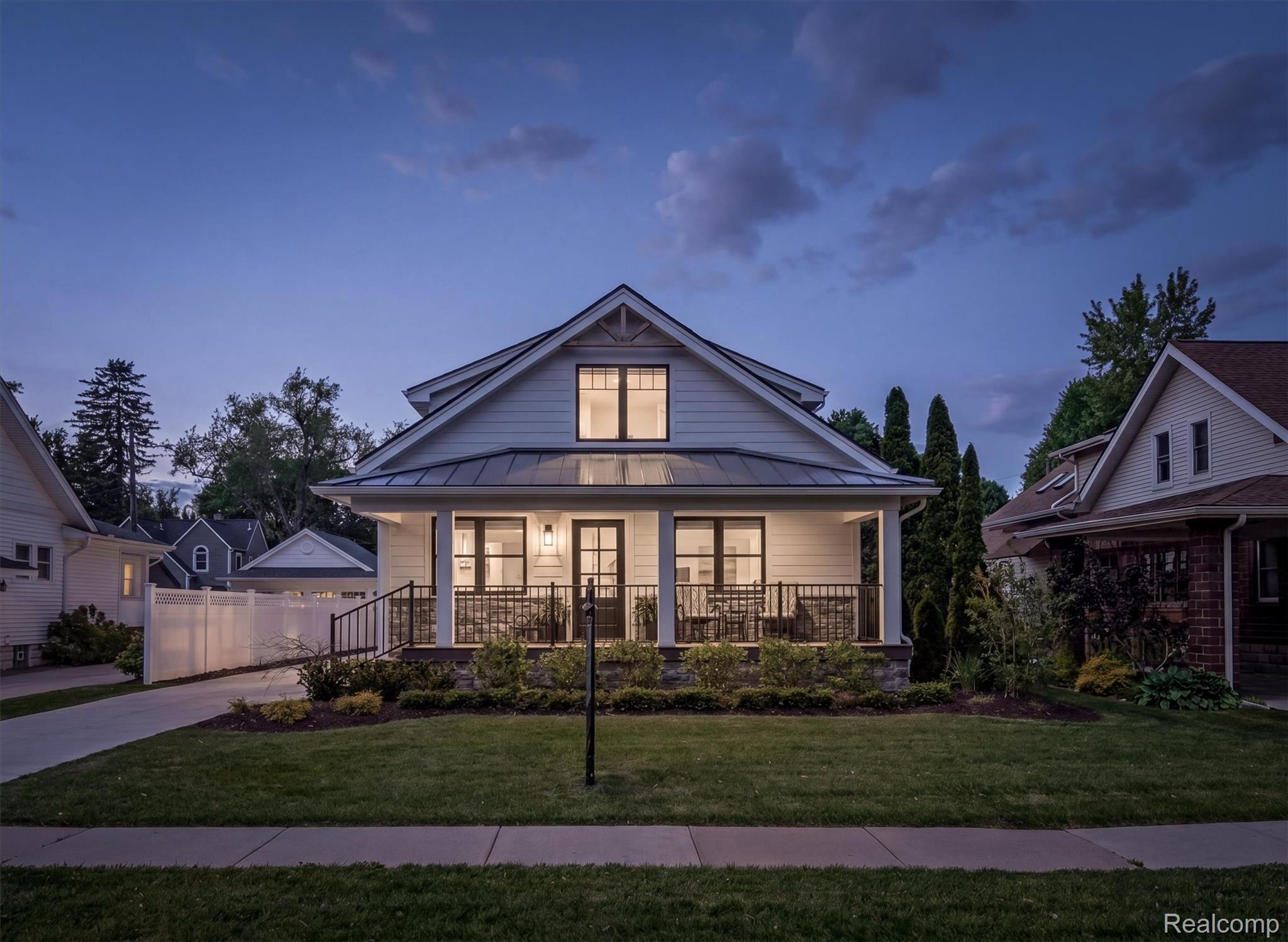 347 Highland Avenue Rochester, MI 48307 - Photo 2 of 59 White siding home featuring a covered front porch, dark-framed windows, a metal roof, and an inviting front lawn