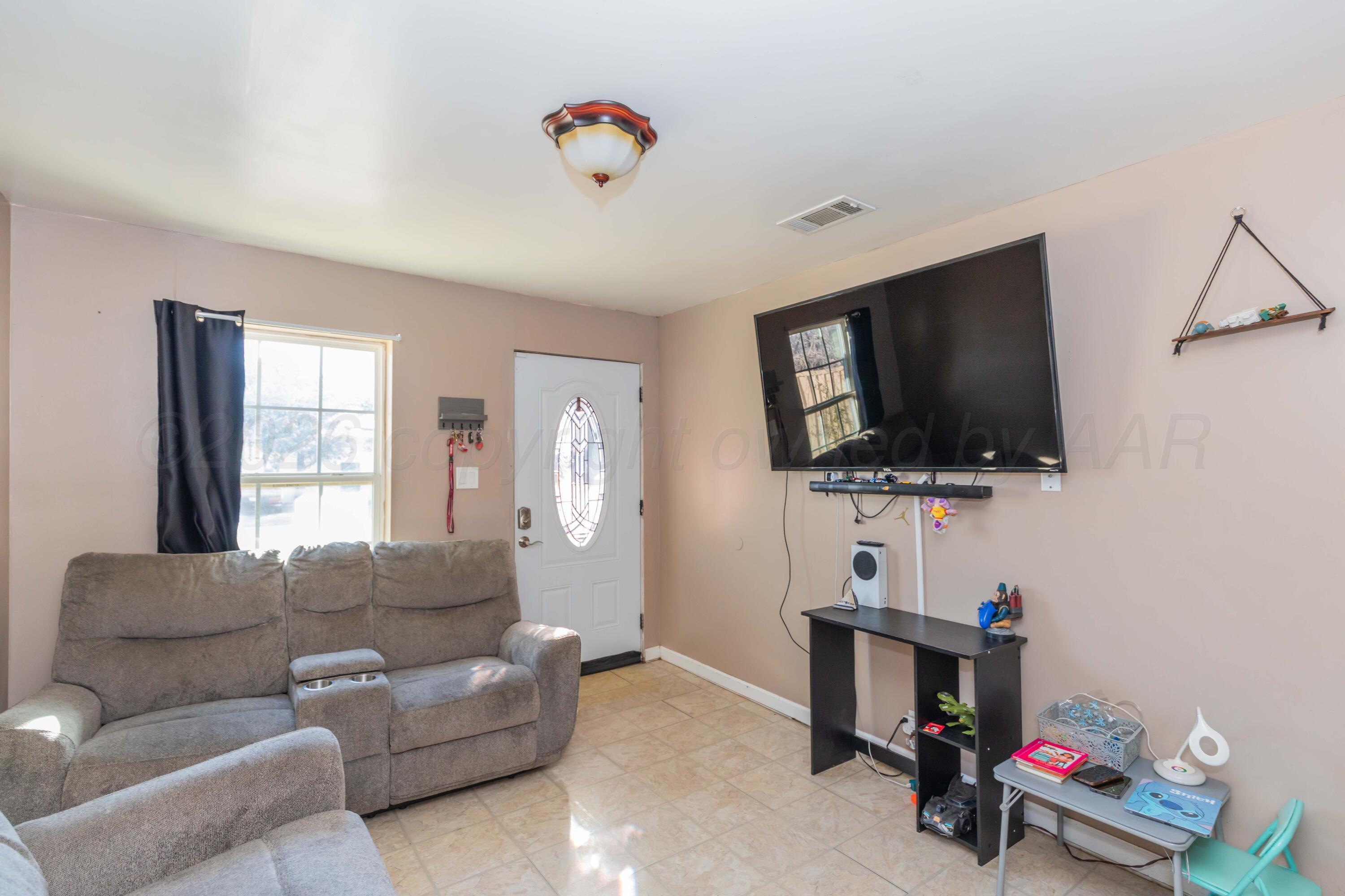 306 Browning Street Amarillo, TX 79104 - Photo 4 of 18 a living room with furniture and a flat screen tv