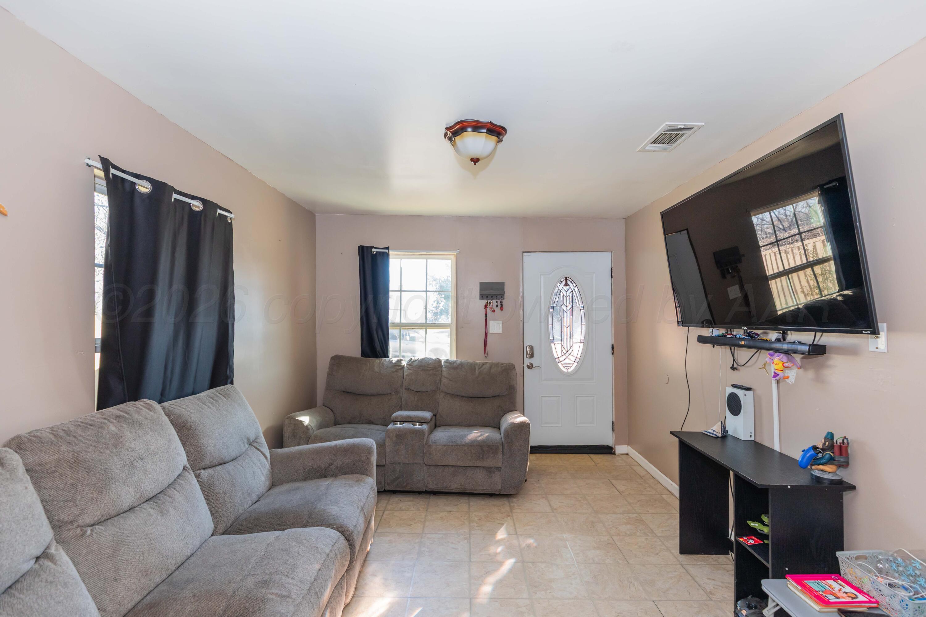 306 Browning Street Amarillo, TX 79104 - Photo 5 of 18 a living room with furniture and a flat screen tv