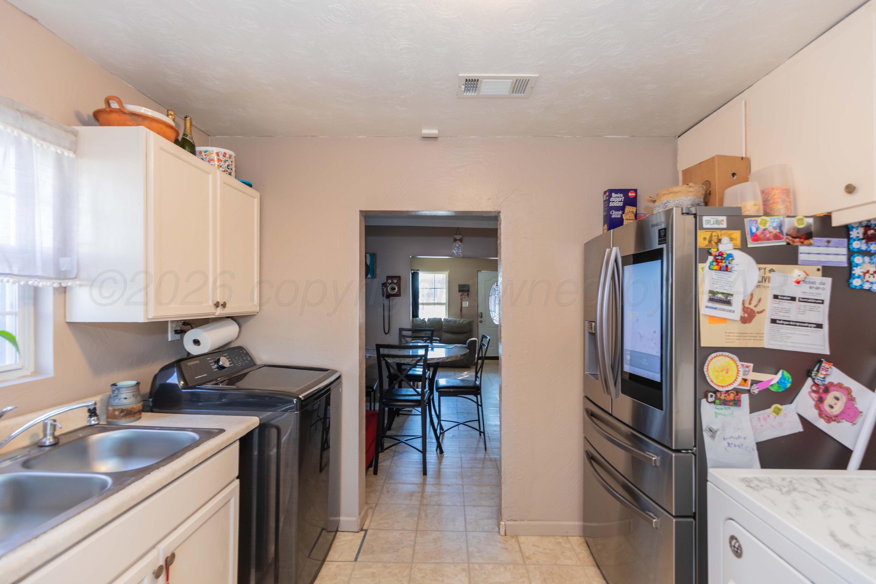 306 Browning Street Amarillo, TX 79104 - Photo 8 of 18 a kitchen with stainless steel appliances granite countertop a refrigerator and a sink