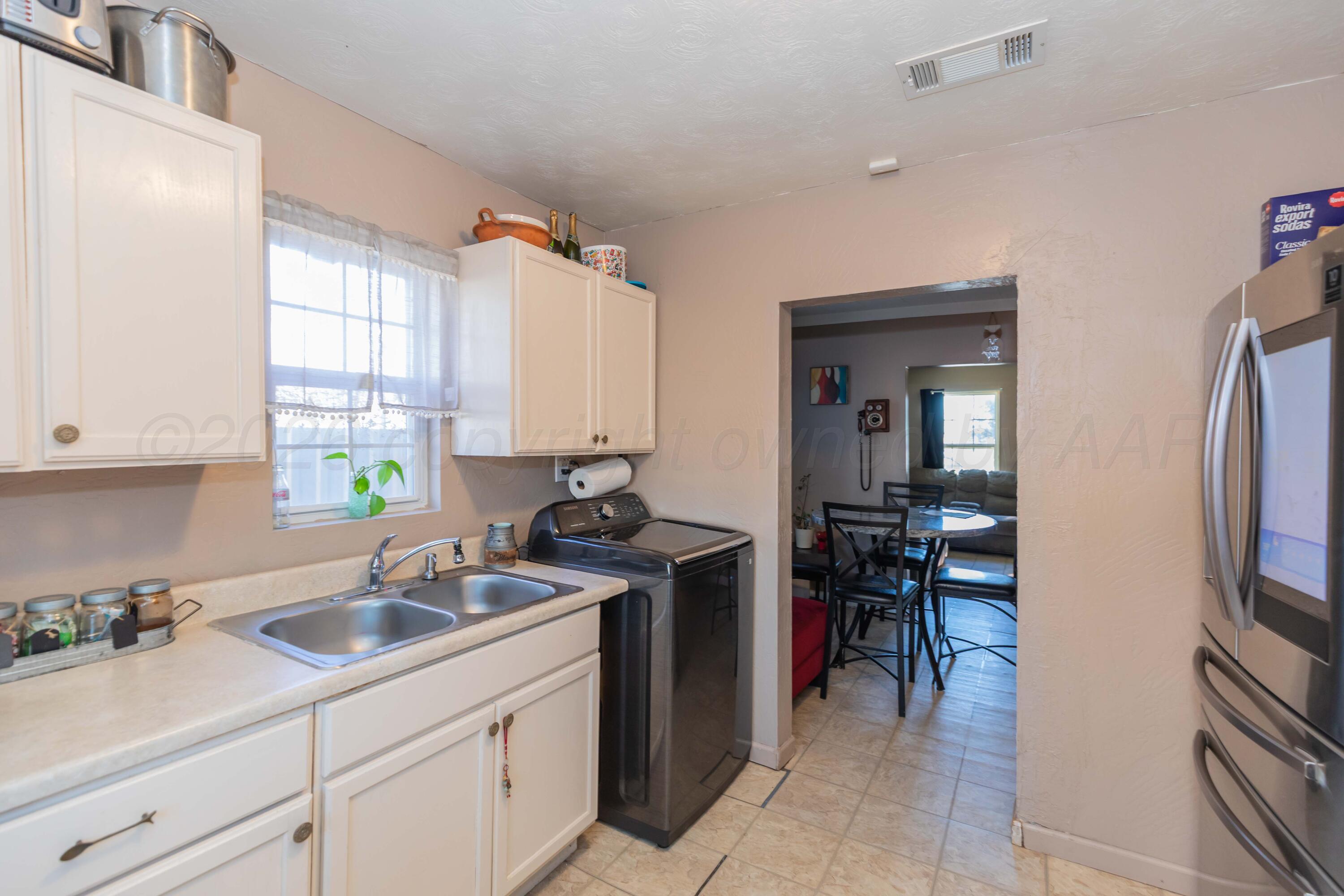 306 Browning Street Amarillo, TX 79104 - Photo 9 of 18 a kitchen with a sink cabinets and appliances