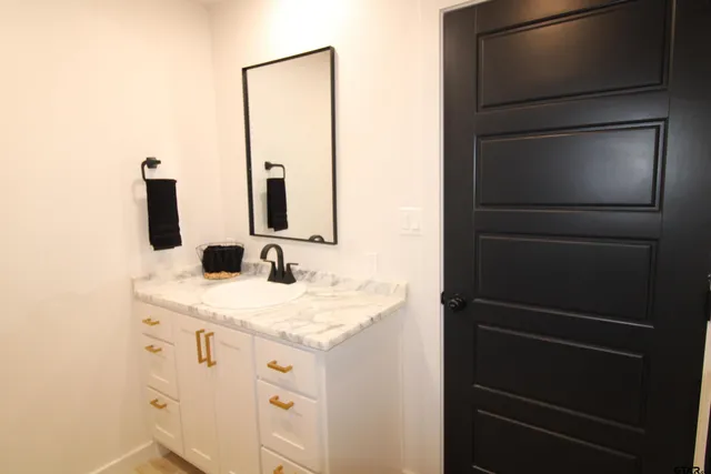 a bathroom with a sink and a mirror